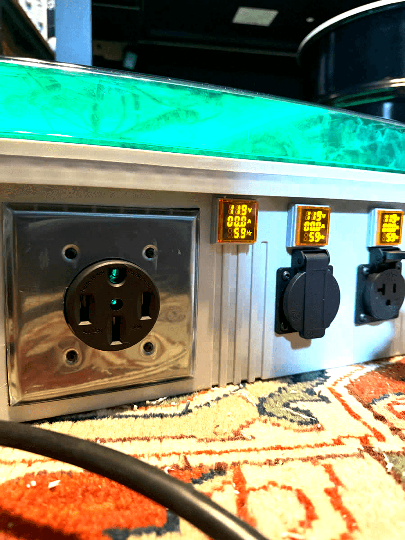 A 50-amp outlet and two smaller outlets on the side of the box, each with a live volt and amp readout.